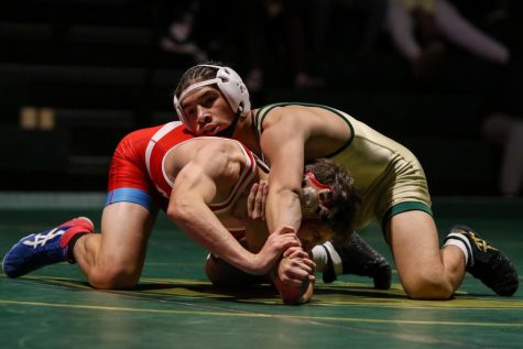 Justin Avila 25 fights for position during a dual meet against Dubuque Senior on Dec. 9.