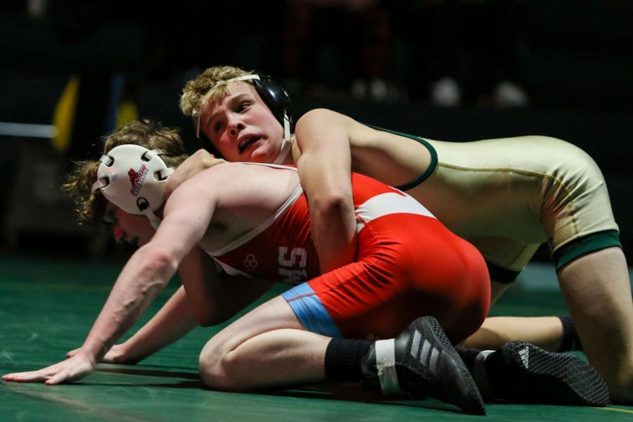 Sterling Warren 25 fights for position during a dual meet against Dubuque Senior on Dec. 9.