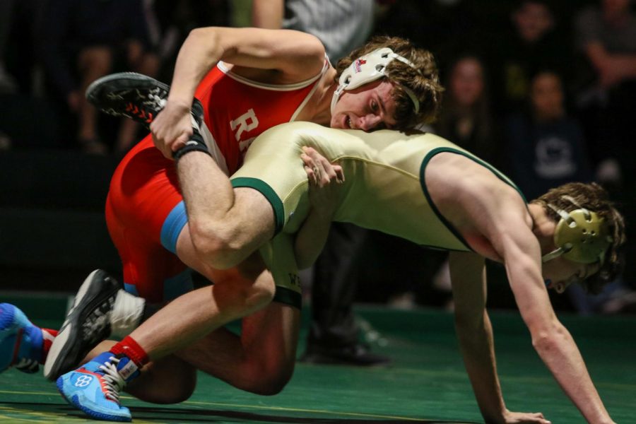 Gordey Gambrall 25 attempts to escape his opponent during a dual meet against Dubuque Senior on Dec. 9.