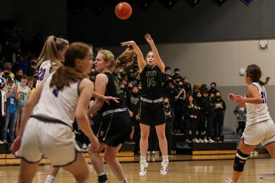 Carolyn Pierce '23 knocks down a three from the top of the key against cross-town rival Liberty on Dec. 10.