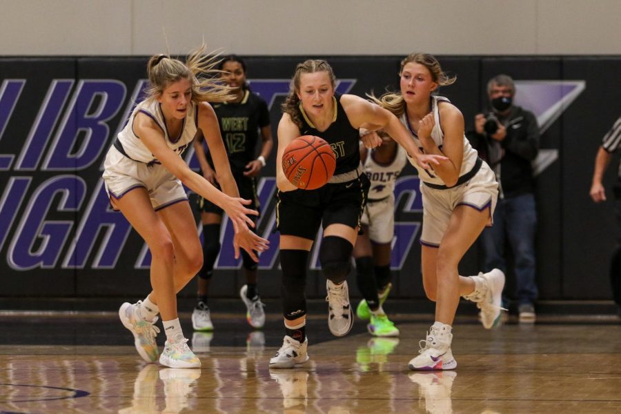 Lucy Wolf '24 fights for a steal against cross-town rival Liberty on Dec. 10.