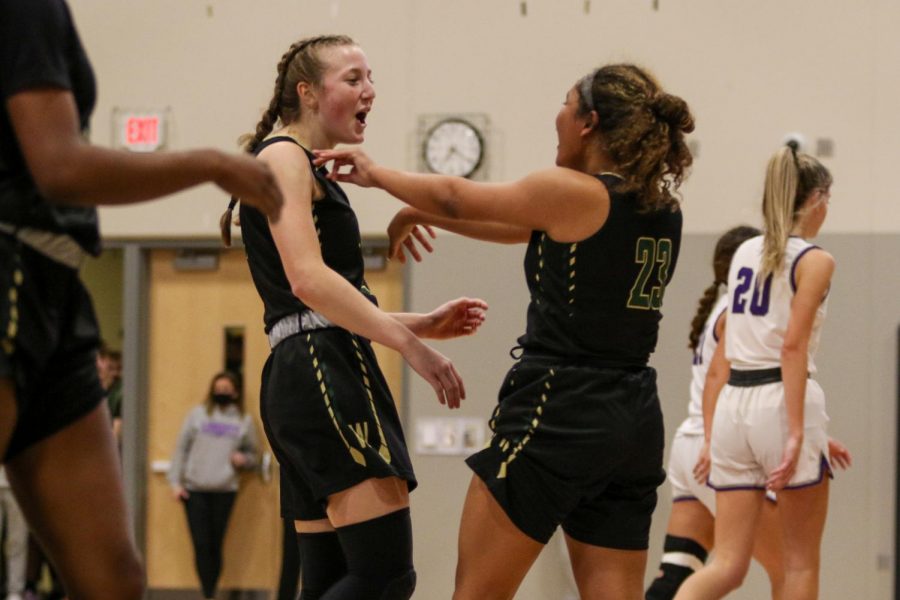 Lucy Wolf 24 and Keiko Ono-Fullard ’23 celebrate forcing a Lightning timeout against cross-town rival Liberty on Dec. 10.