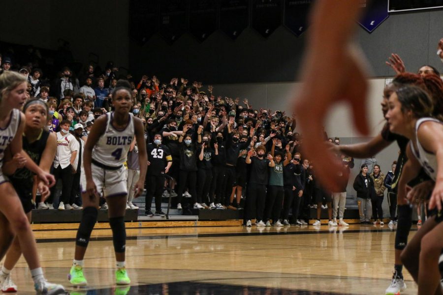 The student section watches from afar as Meena Tate 23 knocks down two free throws against cross-town rival Liberty on Dec. 10.