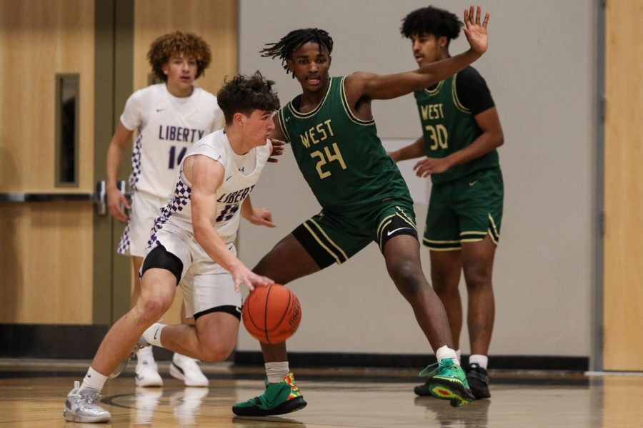 Kareem Earl '24 moves his feet on the defensive end against cross-town rival Liberty on Dec. 10.