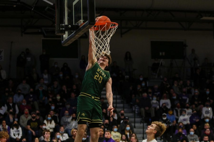 Pete Moe 22 slams home a one-handed dunk against cross-town rival Liberty on Dec. 10.