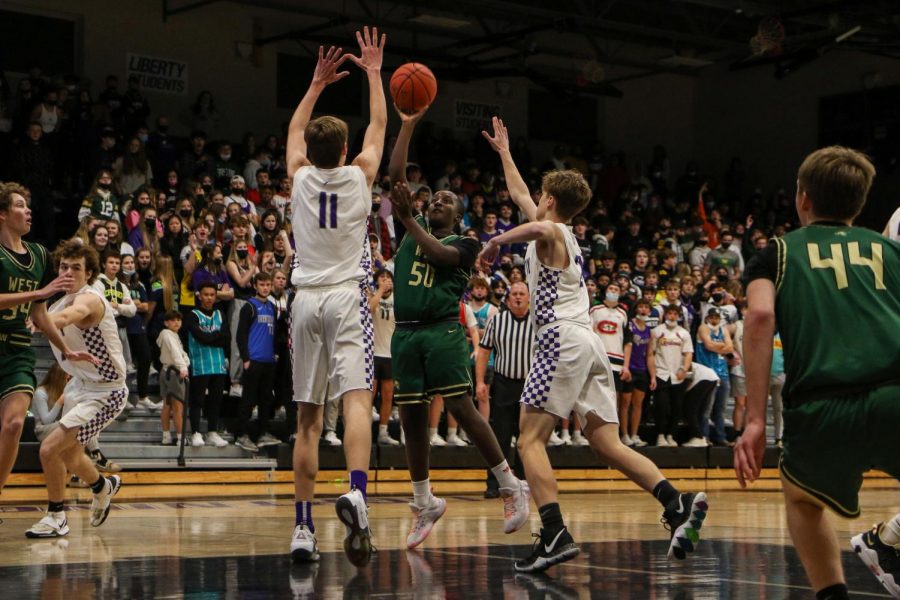 Ayman Bakhit 23 shoots a floater as time expires against cross-town rival Liberty on Dec. 10.