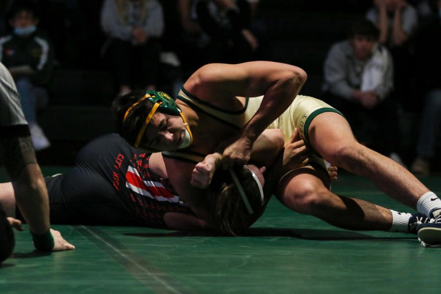 Hunter Garvin 22 works his opponent to his back as he looks for a pin during a dual meet against City High on Dec. 22.