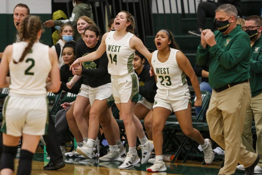 Carolyn Pierce 23 and Keiko Ono-Fullard ’23 celebrate with their teammates after forcing a timeout  against Cedar Rapids Washington on Dec. 3.