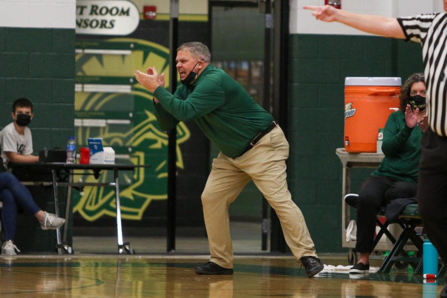 Head Coach BJ Mayer cheers on his players from the sideline against Cedar Rapids Washington on Dec. 3.