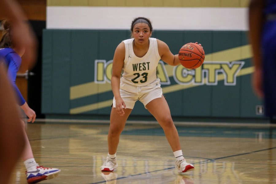 Keiko Ono-Fullard ’23 examines the defense against Cedar Rapids Washington on Dec. 3.