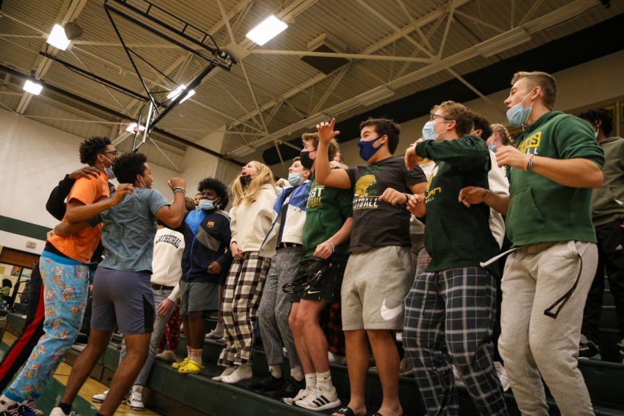 The student section chants "I believe that we just won" after the girls basketball team defeated Cedar Rapids Washington 47-46 on Dec. 3.