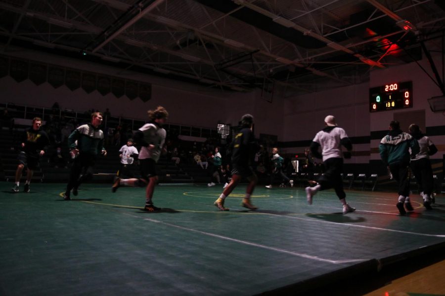 The boys wrestling team makes their way around the mat before facing off with Dubuque Senior on Dec. 9.