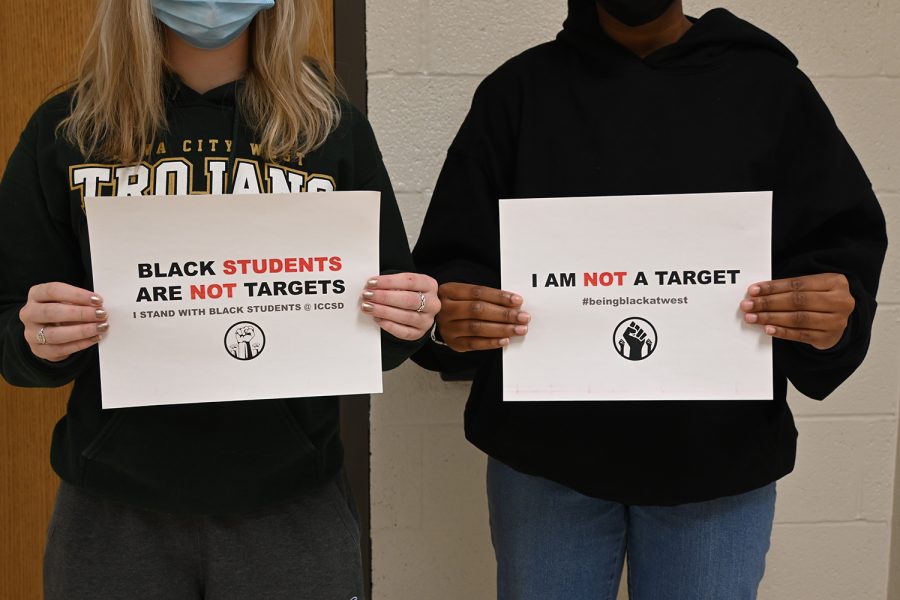 Students hold signs created by the BSU to stand in solidarity with their movement. 