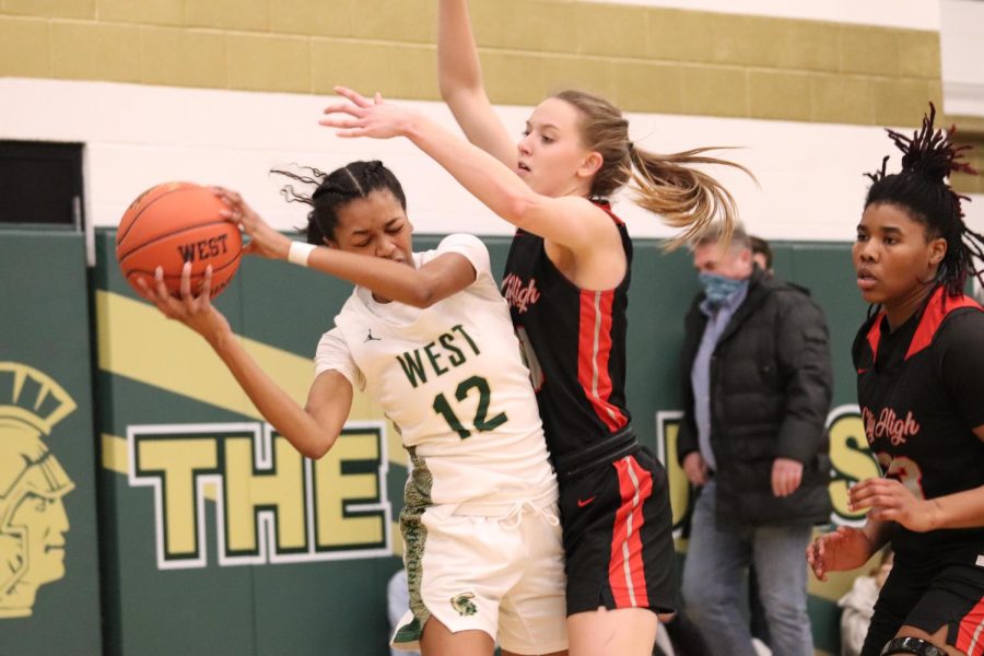 Meena Tate 23 bends to avoid City Highs defense. 