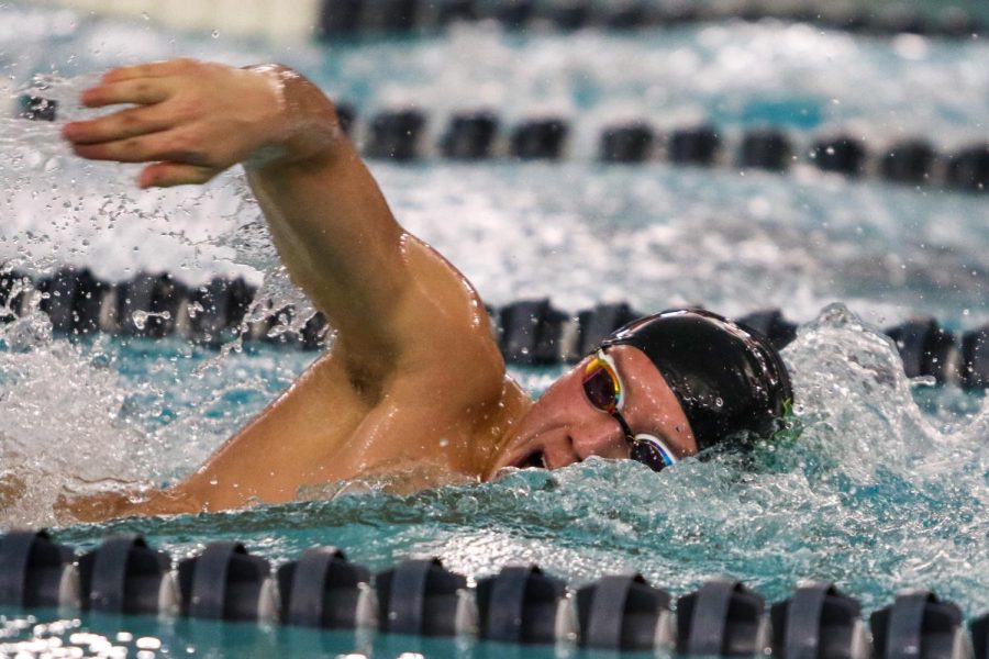 Holden Carter 24 swims his leg of the 200 yard Freestyle Relay during the annual Battle for the Golden Speedo on Jan. 18.