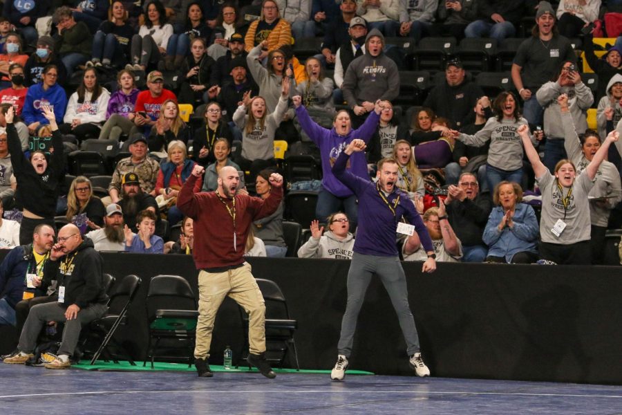Spencer coaches and fans celebrate a pin at the Xtream Arena in Coralville during the 2022 girls state wrestling tournament on Jan. 22.