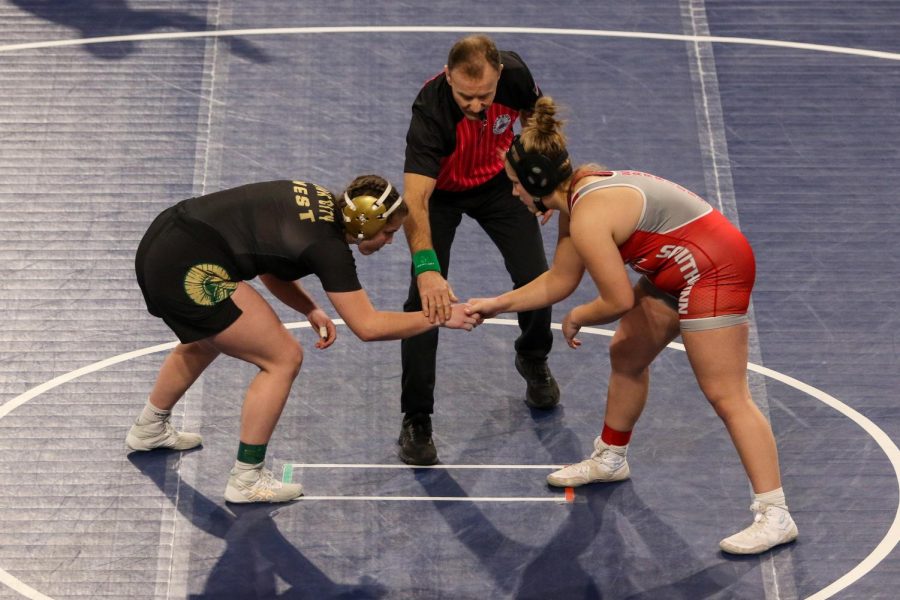 Lexi Nash 23 shakes hands with South Winneshieks Isabelle Kipp 23 before wrestling at the Xtream Arena in Coralville during the 2022 girls state wrestling tournament on Jan. 22.  