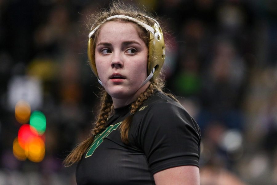 Lexi Nash 23 looks over to her coaches for assistance while wrestling in the consolation bracket at the Xtream Arena in Coralville during the 2022 girls state wrestling tournament on Jan. 22.  