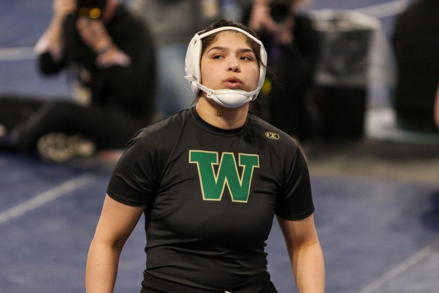 Jannell Avila 23 takes a deep breath before wrestling in the semifinals at the Xtream Arena in Coralville during the 2022 girls state wrestling tournament on Jan. 22.  