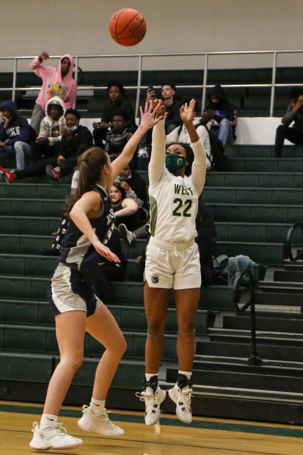 Melae Lacy 24 attempts a corner three in the first game of the doubleheader against Xavier on Jan. 4.
