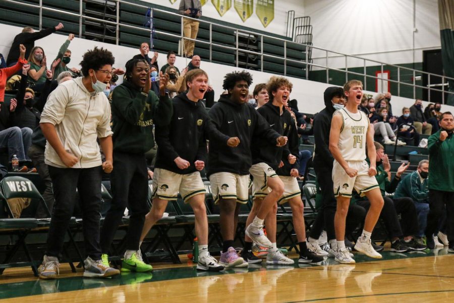The boys basketball bench celebrates a Jacob Koch 24 and-one in the second game of the doubleheader against Xavier on Jan. 4.