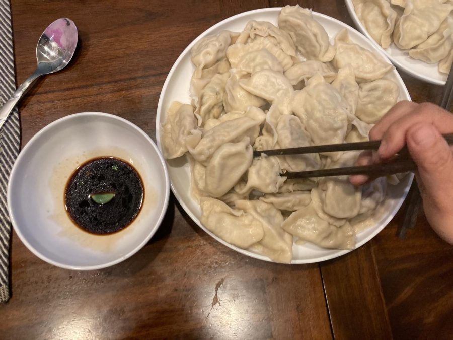 Gianna Lodh 25 shows a fresh bowl of dumplings and dipping sauce.