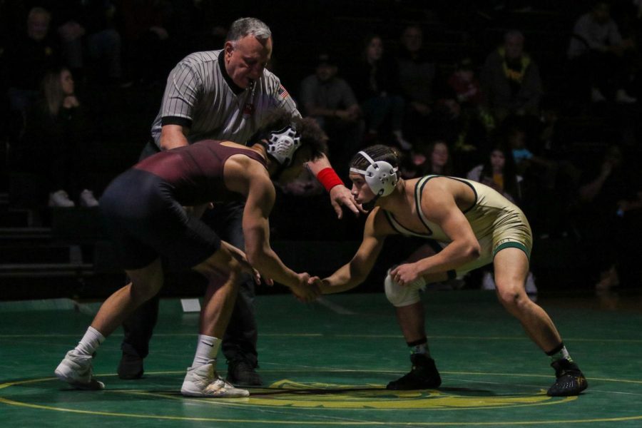 Justin Avila 25 shakes Waterloo Wests Braden Nystrom 22 hand before the start of their match during a dual meet on Feb. 3.