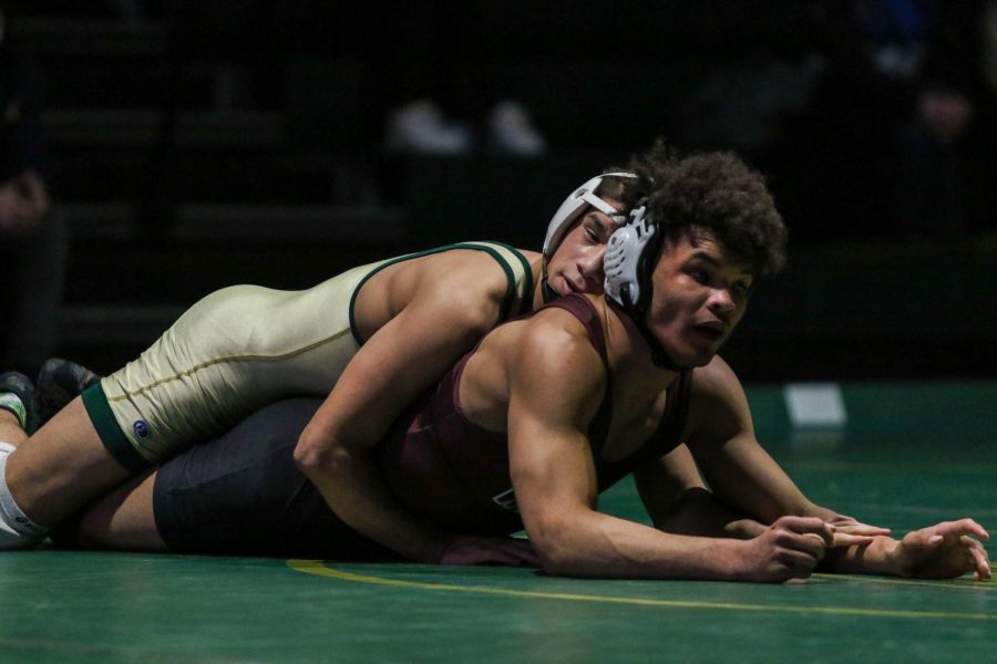 Justin Avila 25 takes down his opponent while wrestling during a dual meet against Waterloo West on Feb. 3.