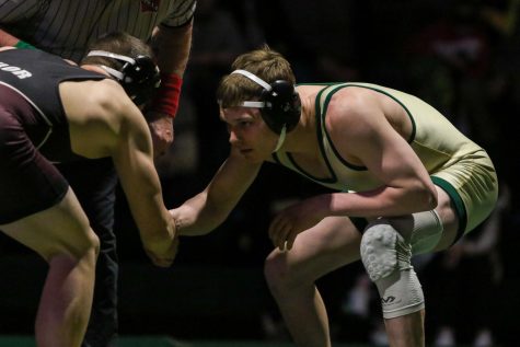 Drake Davis 22 shakes his opponents hand before wrestling during a dual meet against Waterloo West on Feb. 3.