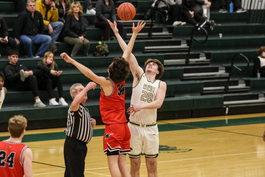 Pete Moe 22 reaches for the jump ball at the start of the Trojans final regular season home game of the year on Feb. 17.