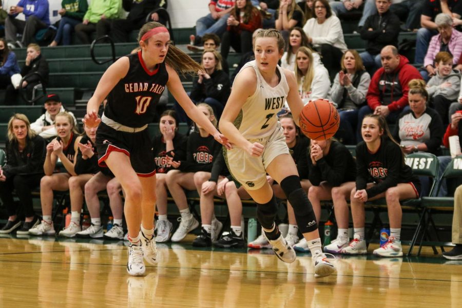 Lucy Wolf 24 drives the baseline against Cedar Falls in the regional semifinal on Feb. 19.