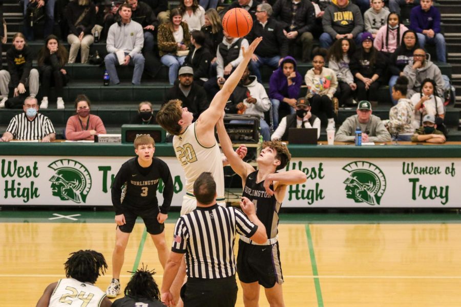 Pete Moe 22 wins the opening tip during the substate semifinal game against Burlington on Feb. 25.