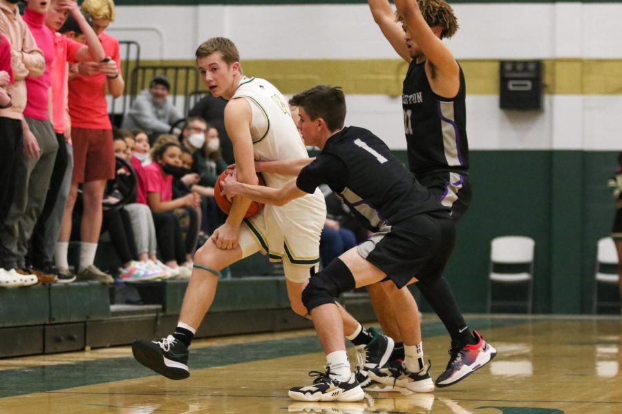 Jacob Koch 23 gets tied up with a Greyhound defender during the substate semifinal game against Burlington on Feb. 25.