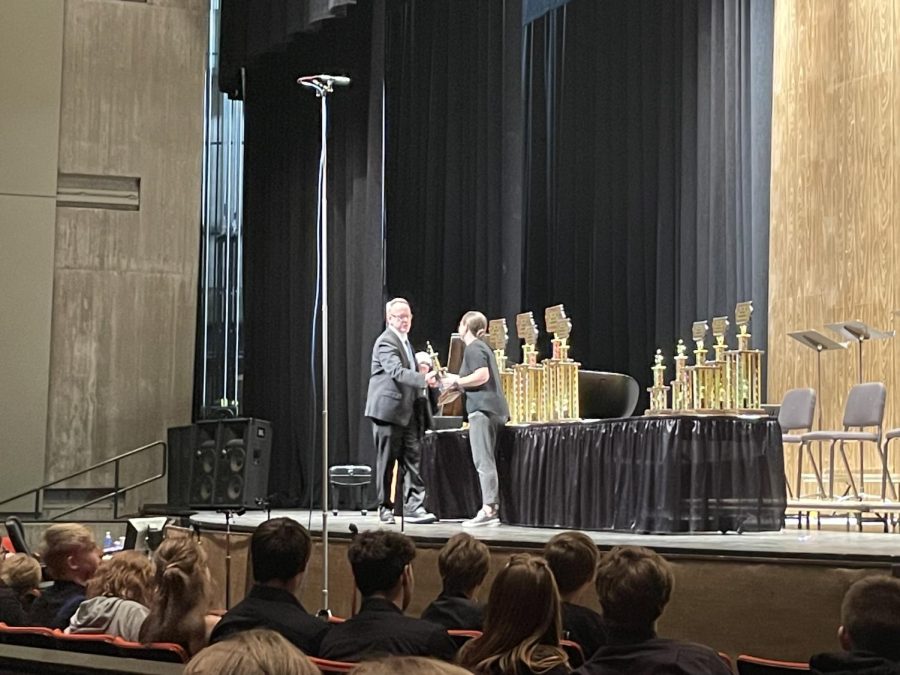 Jazz Ensemble director Rich Medd accepts the 7th place trophy at the Iowa Jazz Championships awards ceremony