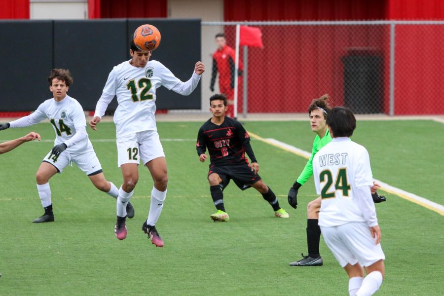 Adarsh Khullar 24 heads the ball out of the box against City High on April 15.
