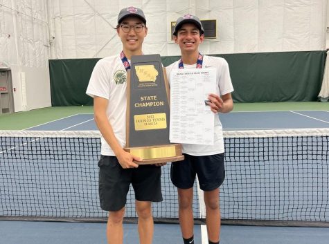 Jayden Shin 23 and Samir Singh 24 pose for a photo with their championship trophy and bracket during the state singles/doubles tournament at the Hawkeye Tennis & Recreation Complex on May 25.
