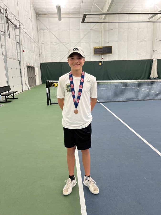 Seth Smigel 25 poses for a photo with his 6th place medal during the state singles/doubles tournament at the Hawkeye Tennis & Recreation Complex on May 25.