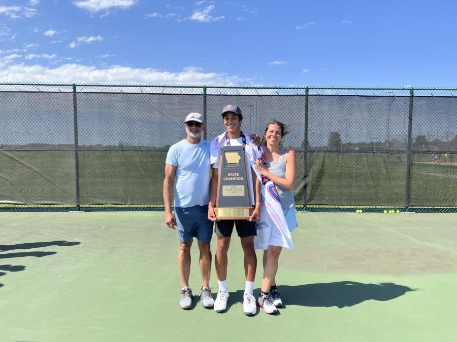 Senior Luca Chackalackal and his parents pose for a photo with the team championship trophy and banner after the conclusion of team state at the Prairie Ridge Sports Complex on May 31.