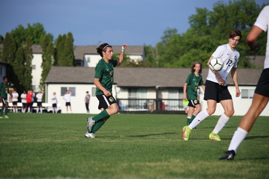 Miguel Cohen Suarez 22 chips the ball past two Cedar Falls defenders on May 25 in the substate final.