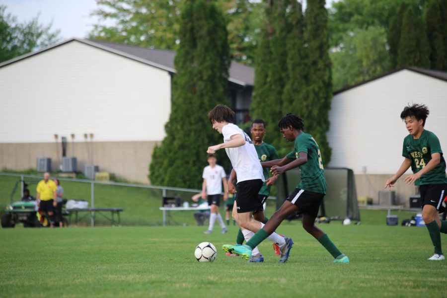 Sophomore Ismail Mohamed fights for possession in the first half of the substate final against Cedar Falls.
