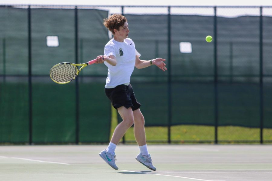 Patrick Selby 24 gets around a ball in preparation to hit a forehand during the IHSAA District Tennis Tournament at West High on May 9.