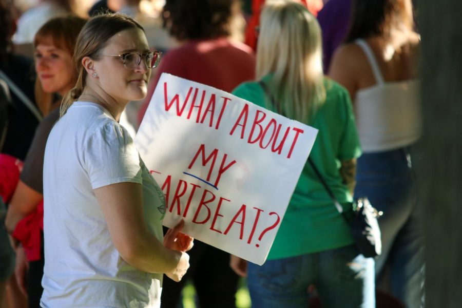 A protester holds a sign that says what about my heartbeat? during the protest on June 24, 2022. 