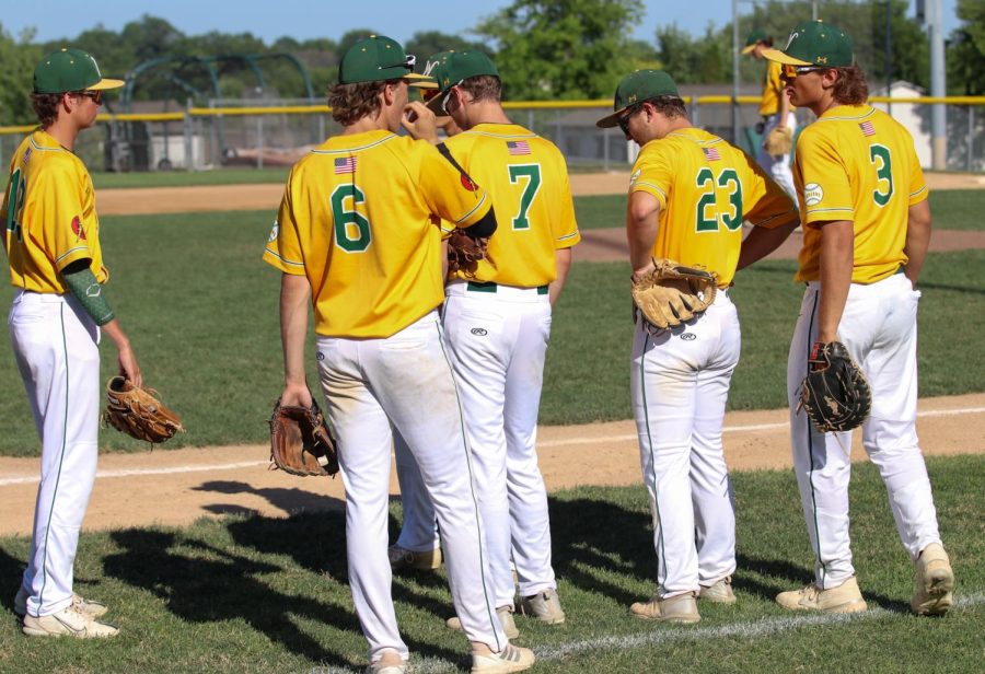 The team huddles before the second game of the double header against Cedar Falls starts on June 17, 2022. 