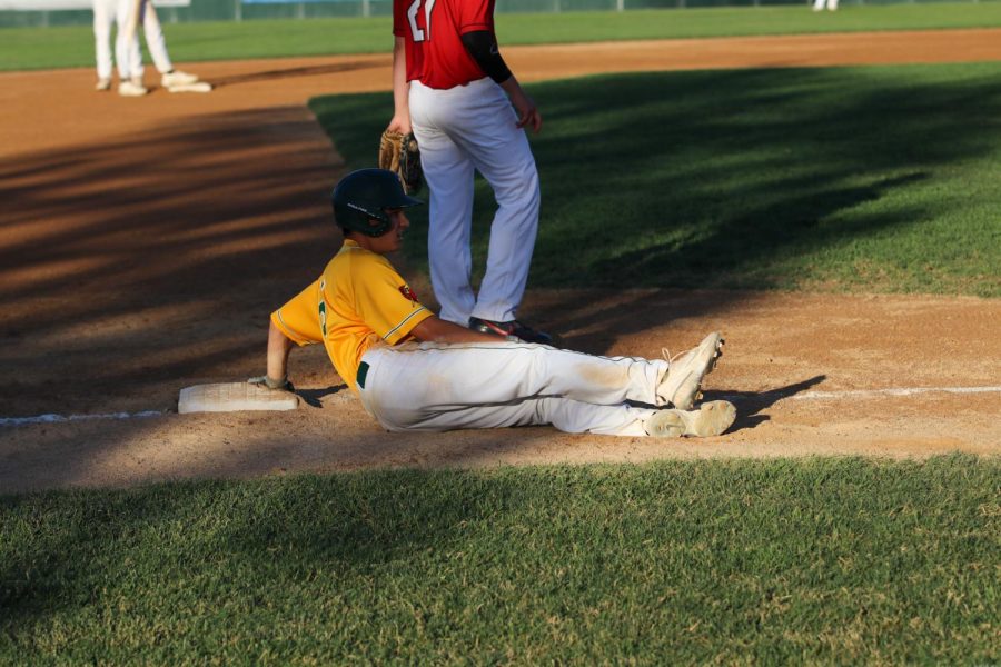 Nate Gudenkauf 22 slides on third base during the second game against Cedar Falls on June 17, 2022.