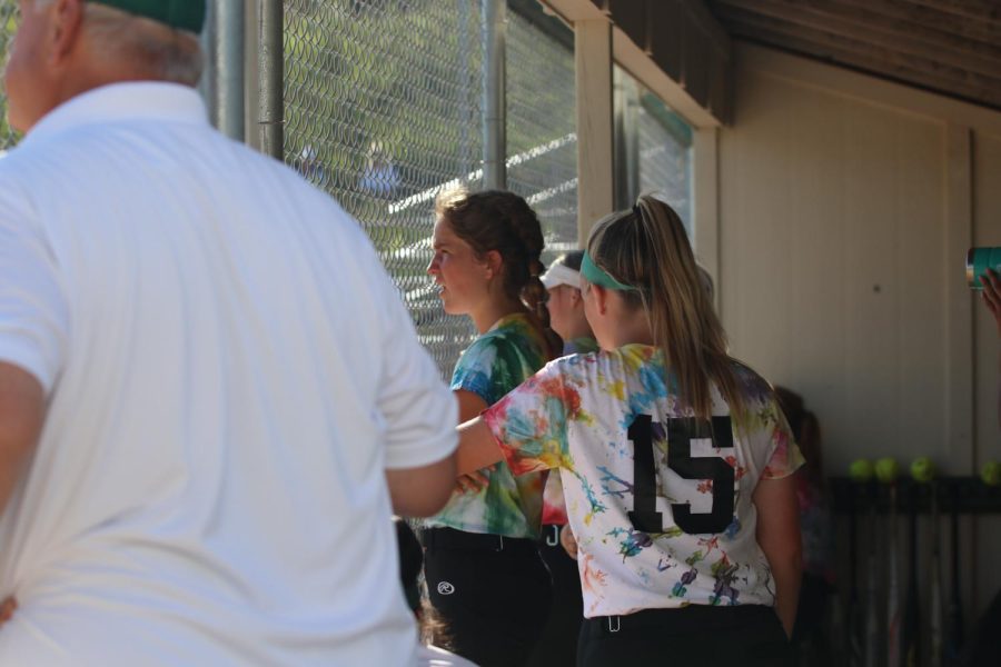 Whitney Noeller 24 and Cameron Hopkins 22 discuss the game against City High in the dugout on June 22, 2022.