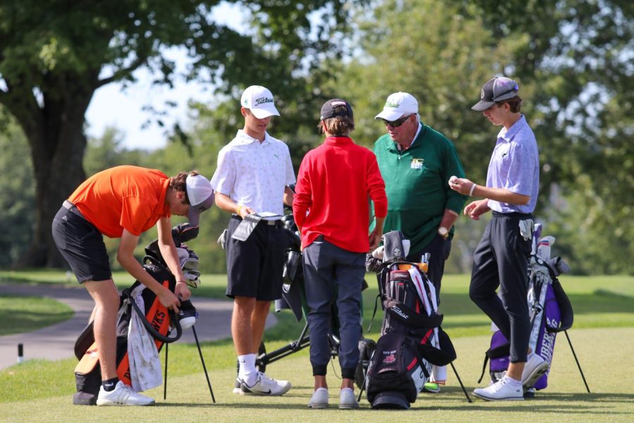 Coach Don Bristow chats with the first seed golfers from all teams before the start of the tournament on Sep. 29, 2022.