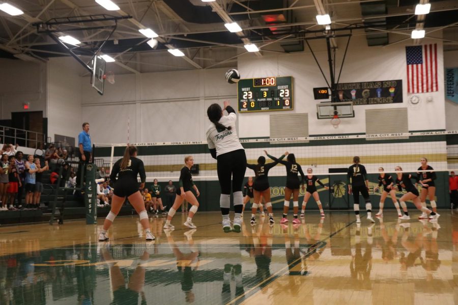 Alaina Greenlee serves during the third set of the volleyball match against City High on Oct. 4, 2022.