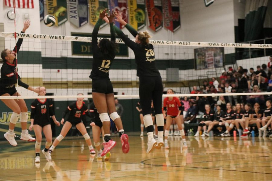 Melae Lacey 24 and Sophia Deyak 23 block a kill from City High on Oct. 4, 2022.