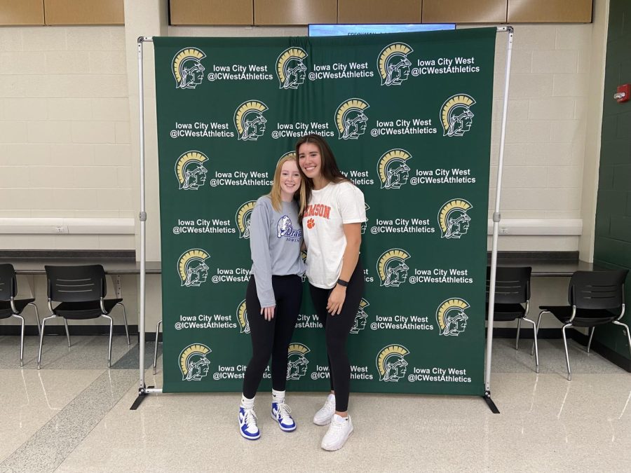 Camille Gretter 23 and Emily Elizalde 23 pose for a photo in the West High cafeteria moments before signing their National Letters of Intent Nov. 9.