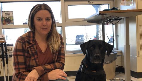 ELL teacher Jessica St. John poses with her service dog, Victor at school.